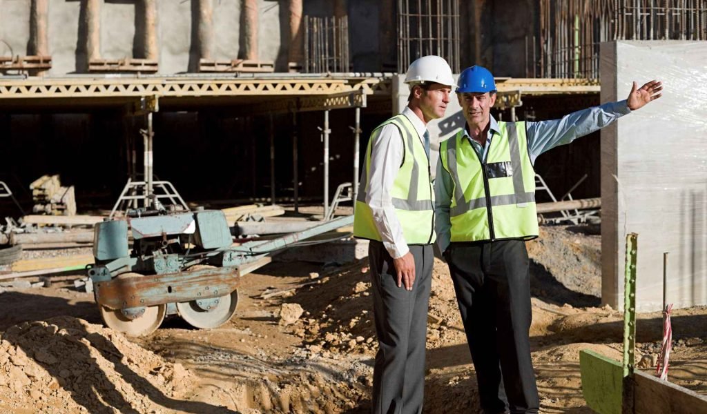two-construction-workers-discussing-plans-on-site-2024-06-05-18-36-48-utc_11zon.jpg